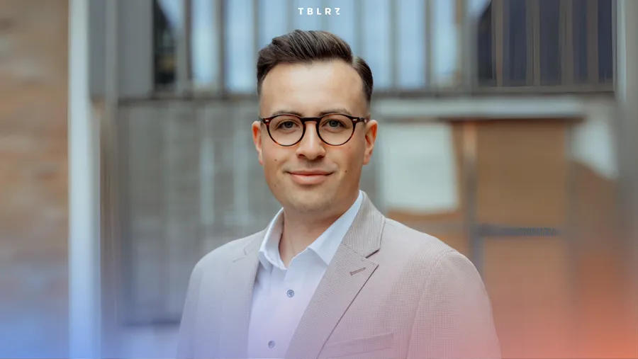 a man wearing glasses and a suit