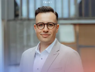 a man wearing glasses and a suit a man wearing glasses and a suit