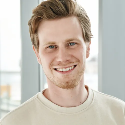 a man smiling at the camera